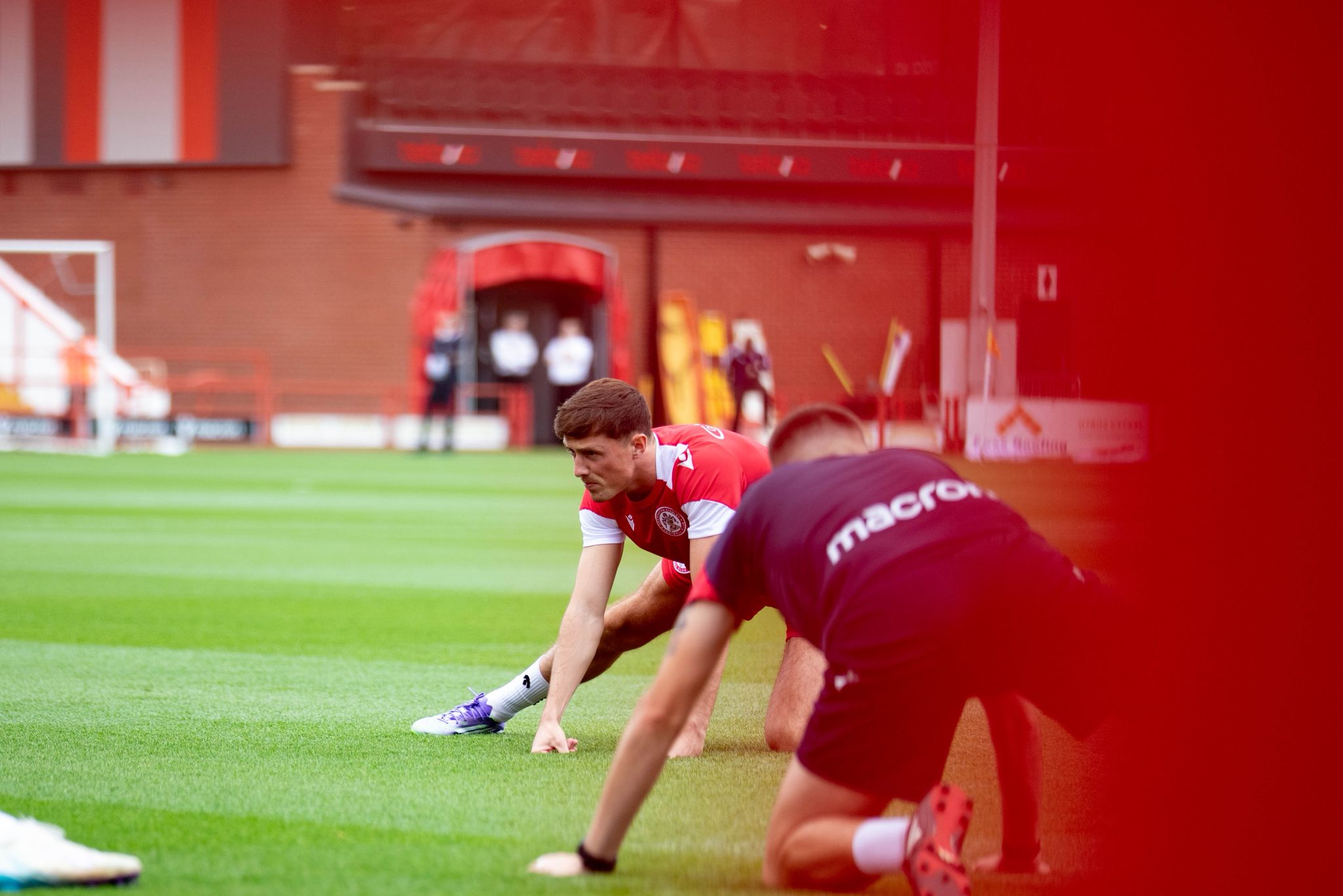 Accrington Stanley FC Soccer players on a field with a blurred background